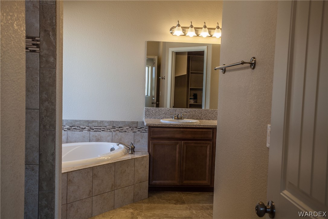 4861 North Neal Ranch Road Kingman, AZ 86401 - Photo 25 of 36 a bathroom with a sink and a mirror
