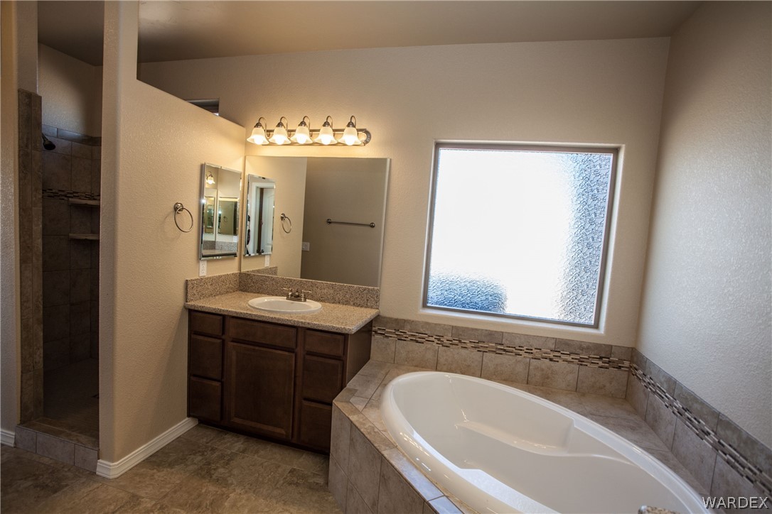 4861 North Neal Ranch Road Kingman, AZ 86401 - Photo 27 of 36 a bathroom with a tub sink and mirror