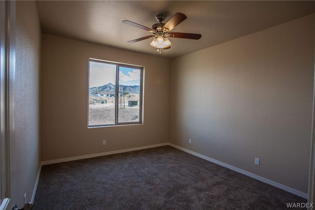 4861 North Neal Ranch Road Kingman, AZ 86401 - Photo 32 of 36 an empty room with a window and a fan