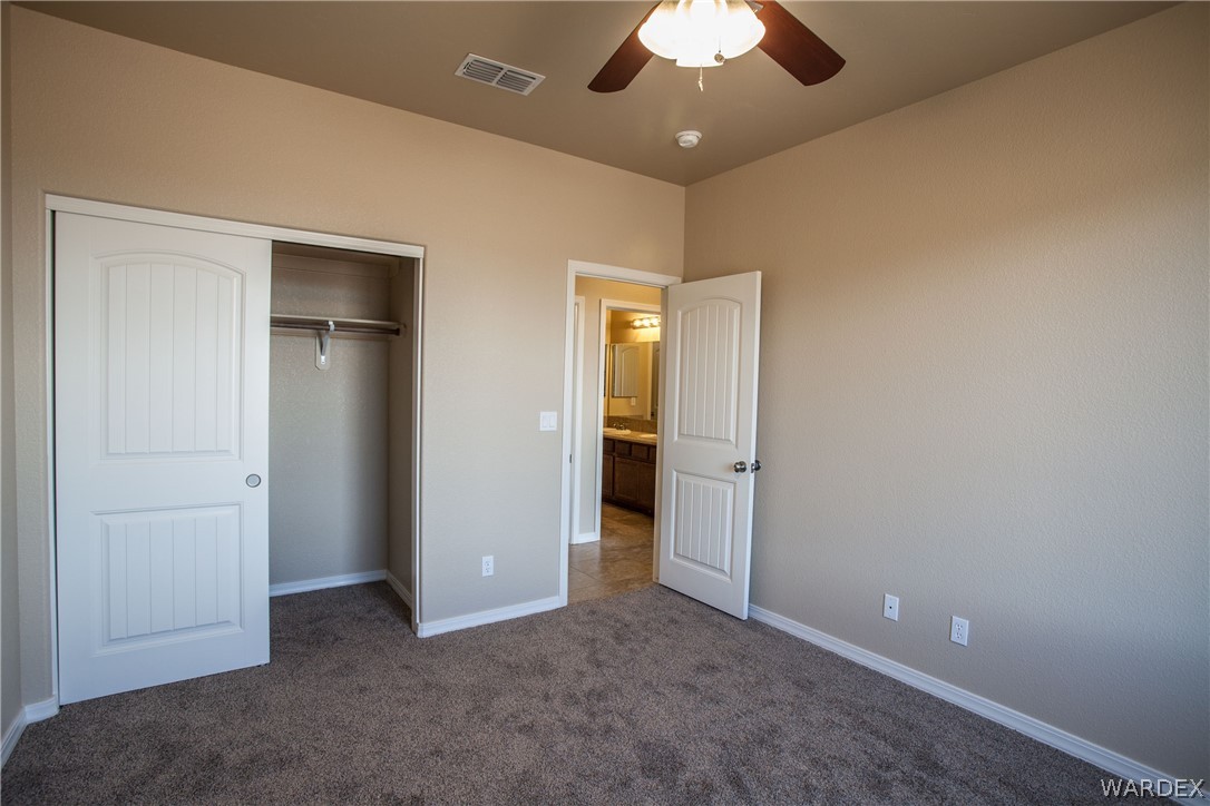 4861 North Neal Ranch Road Kingman, AZ 86401 - Photo 33 of 36 an empty room with closet and a ceiling fan