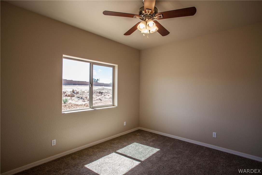 4861 North Neal Ranch Road Kingman, AZ 86401 - Photo 34 of 36 an empty room with windows and fan