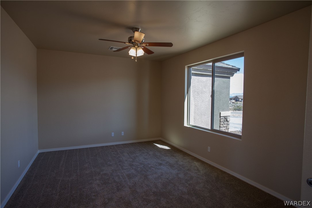 4861 North Neal Ranch Road Kingman, AZ 86401 - Photo 5 of 36 an empty room with windows and fan
