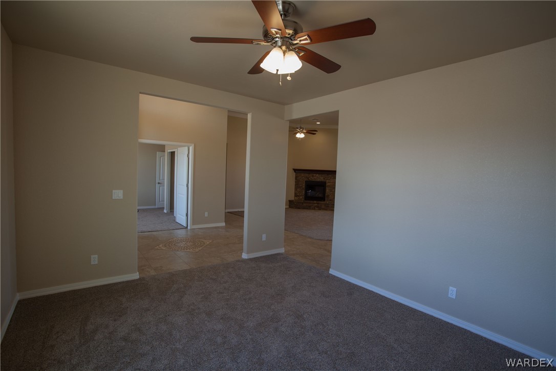 4861 North Neal Ranch Road Kingman, AZ 86401 - Photo 6 of 36 en empty room with closet and a chandelier fan