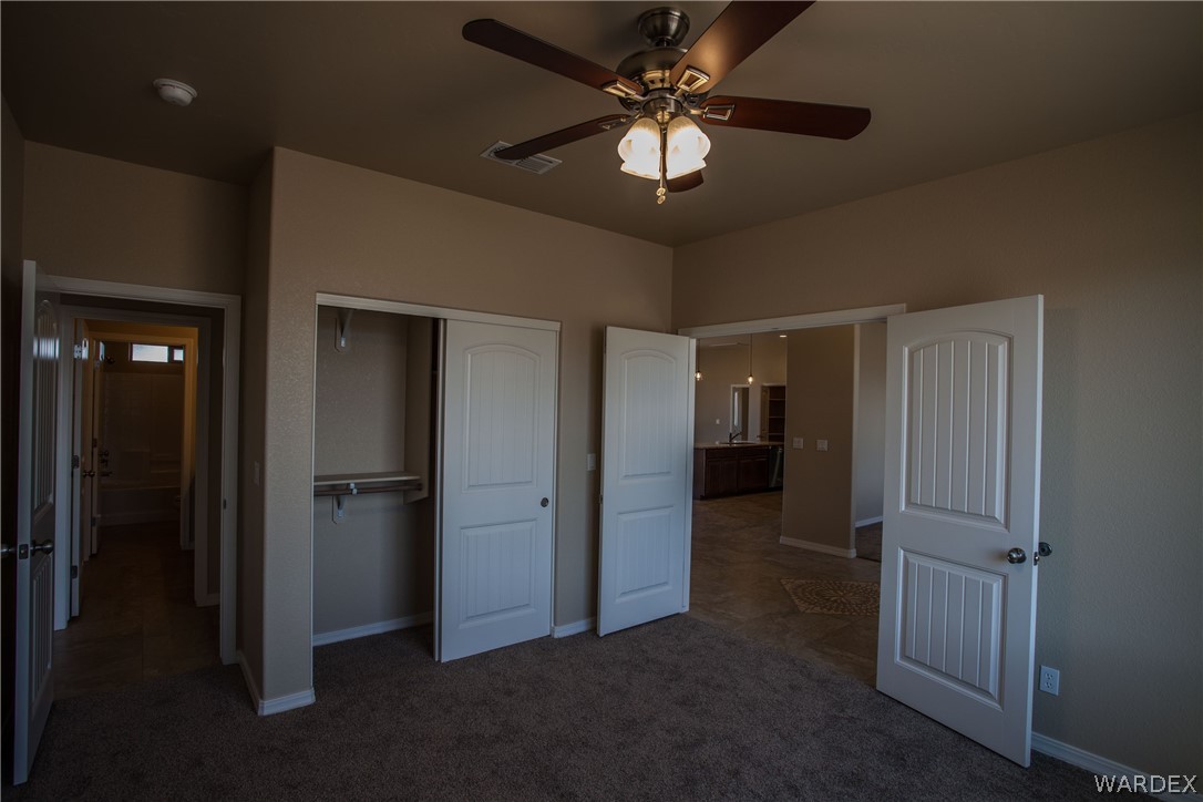 4861 North Neal Ranch Road Kingman, AZ 86401 - Photo 10 of 36 an empty room with closet and a ceiling fan