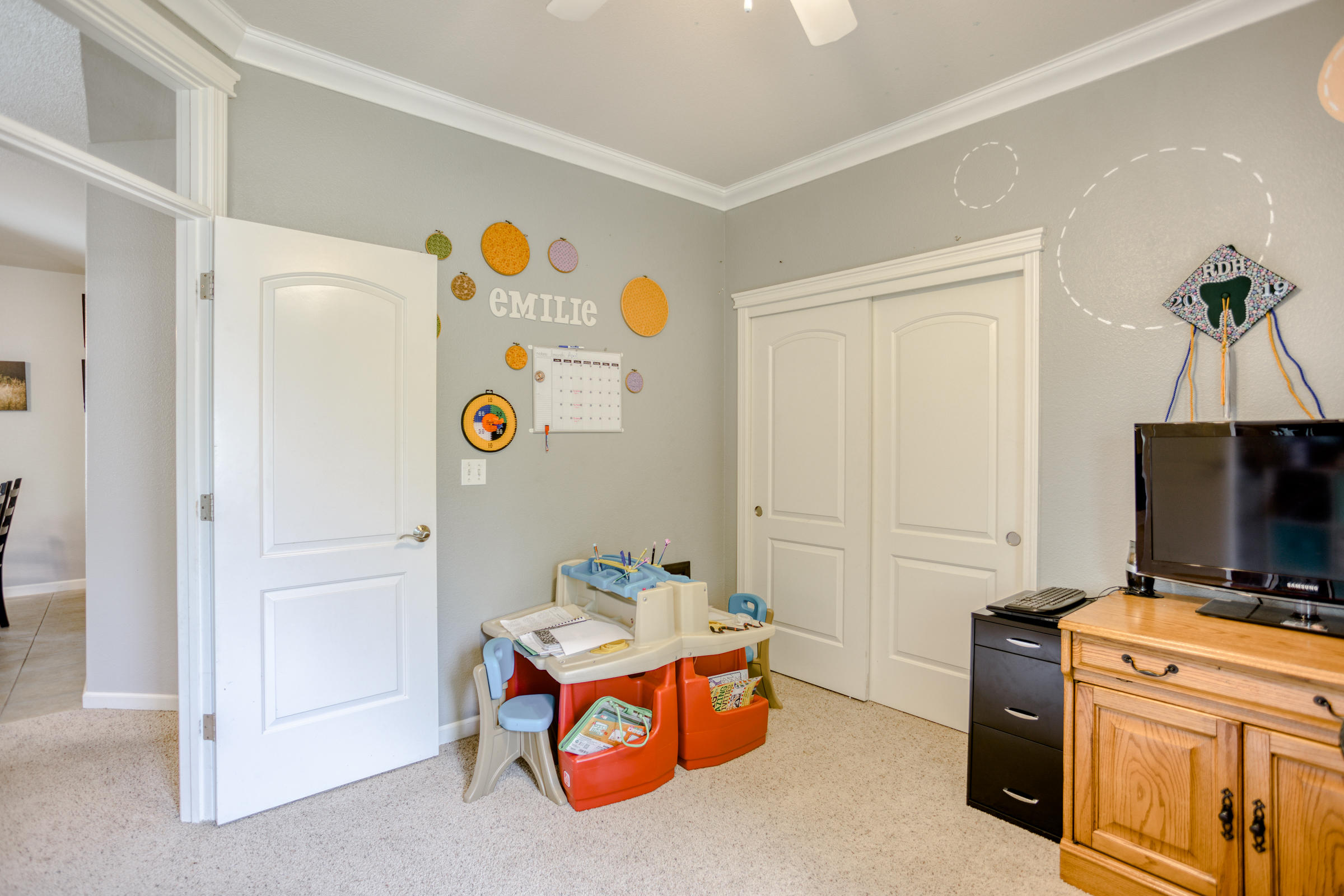 2618 Rhinestone Way Redding, CA 96001 - Photo 19 of 58 a bedroom with a bed and a flat screen tv