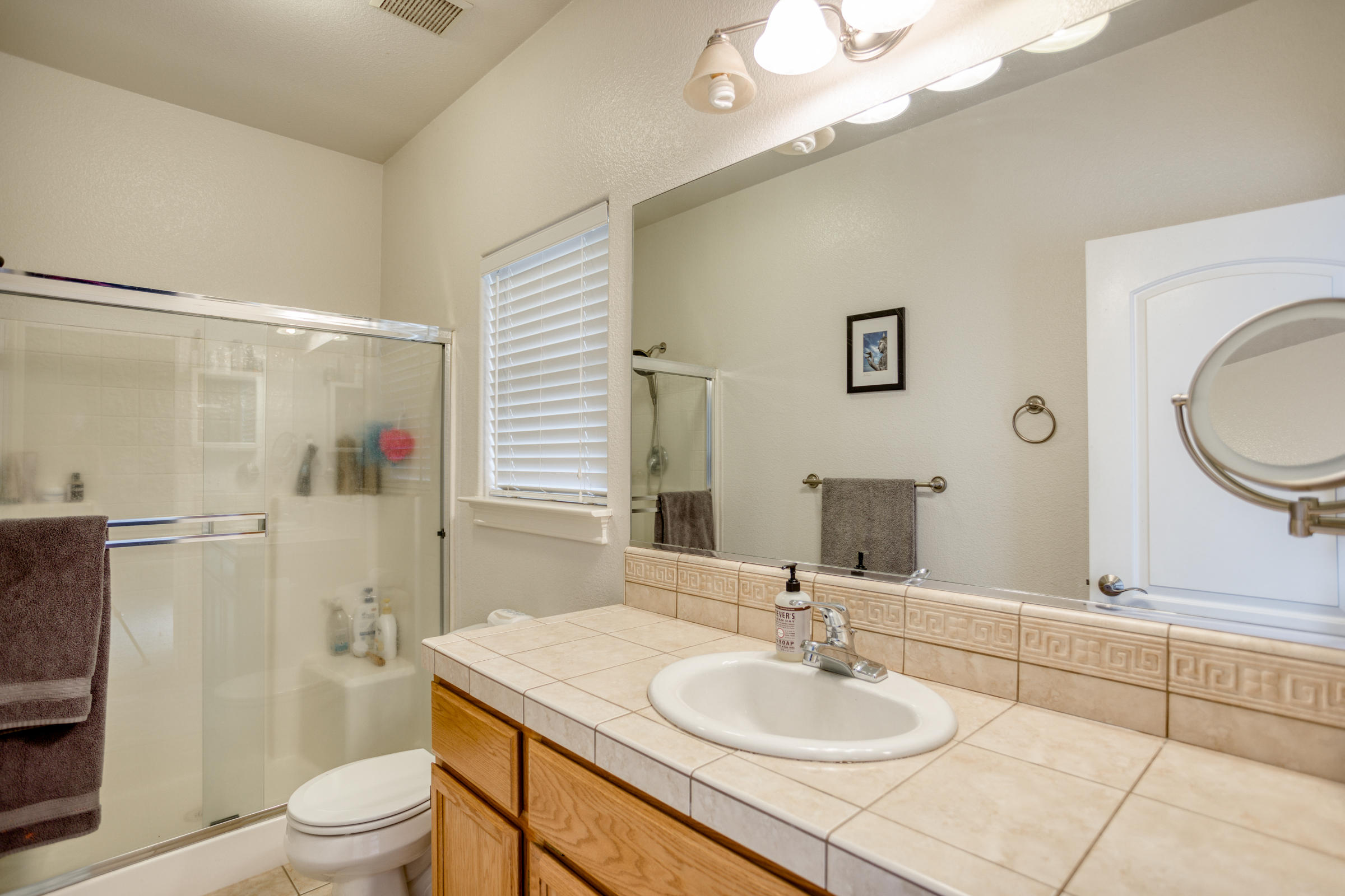 2618 Rhinestone Way Redding, CA 96001 - Photo 22 of 58 a bathroom with a sink toilet a mirror and shower