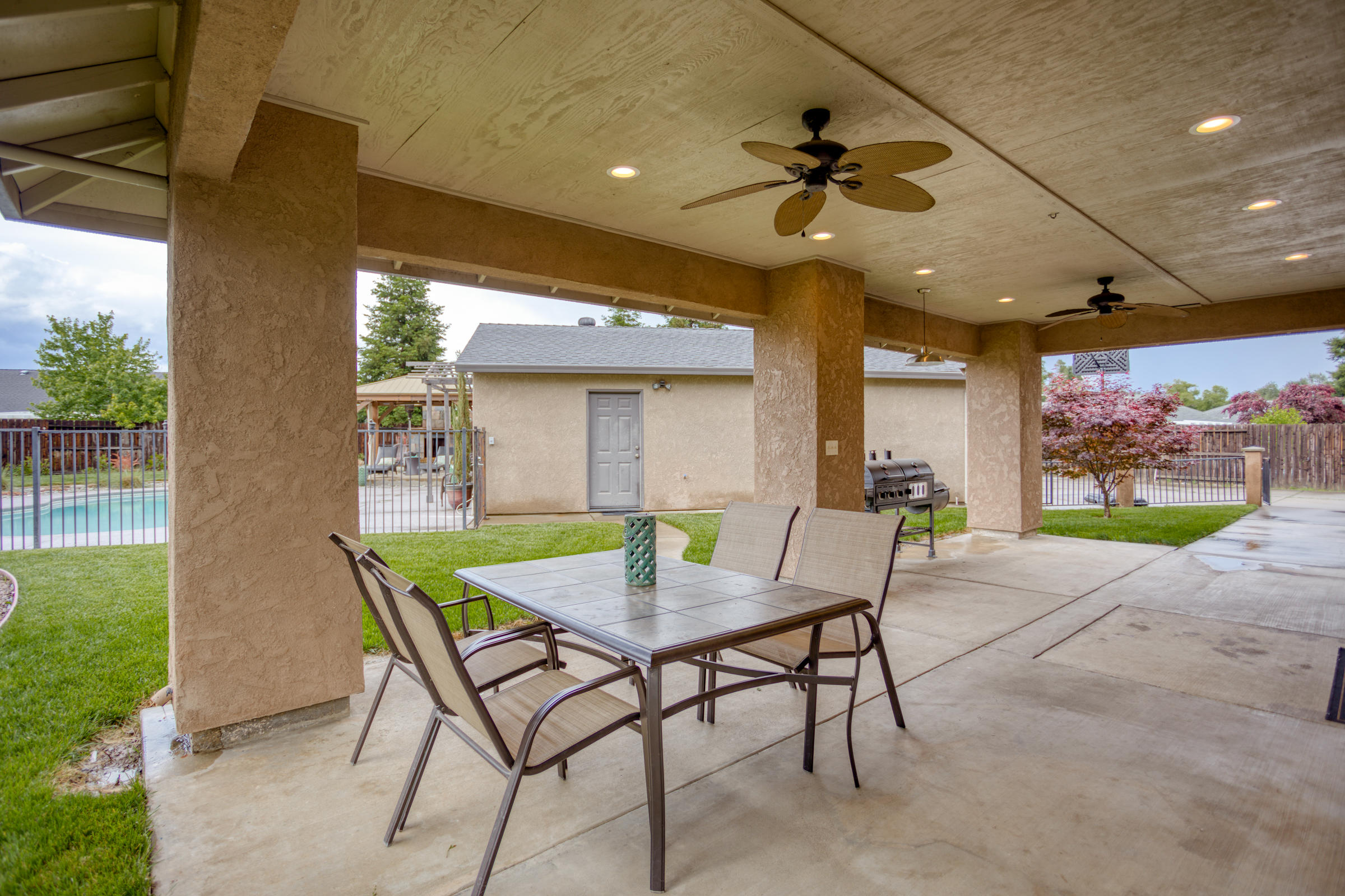 2618 Rhinestone Way Redding, CA 96001 - Photo 34 of 58 a view of an outdoor dining space with a table and chairs