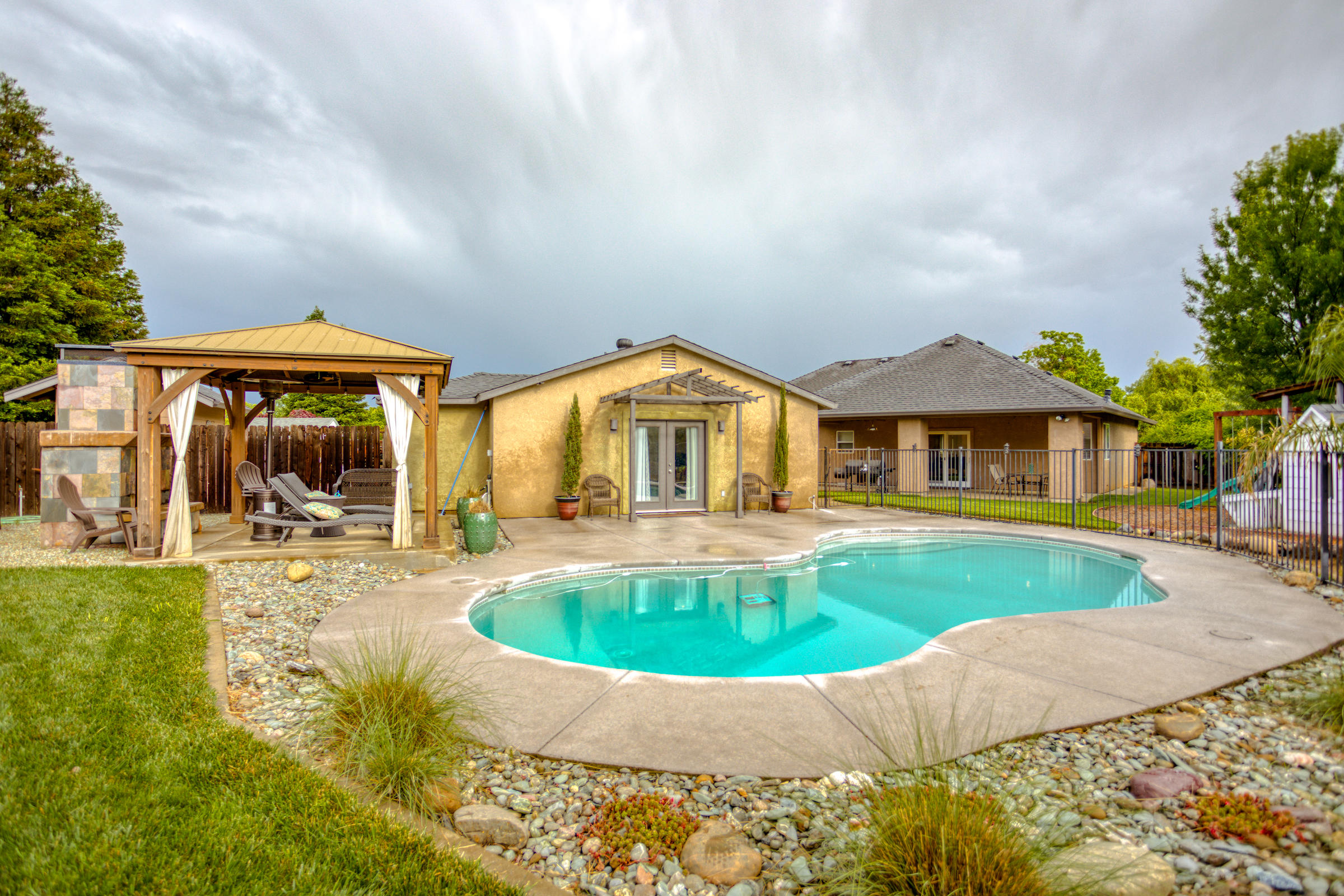 2618 Rhinestone Way Redding, CA 96001 - Photo 40 of 58 a front view of house with yard and swimming pool
