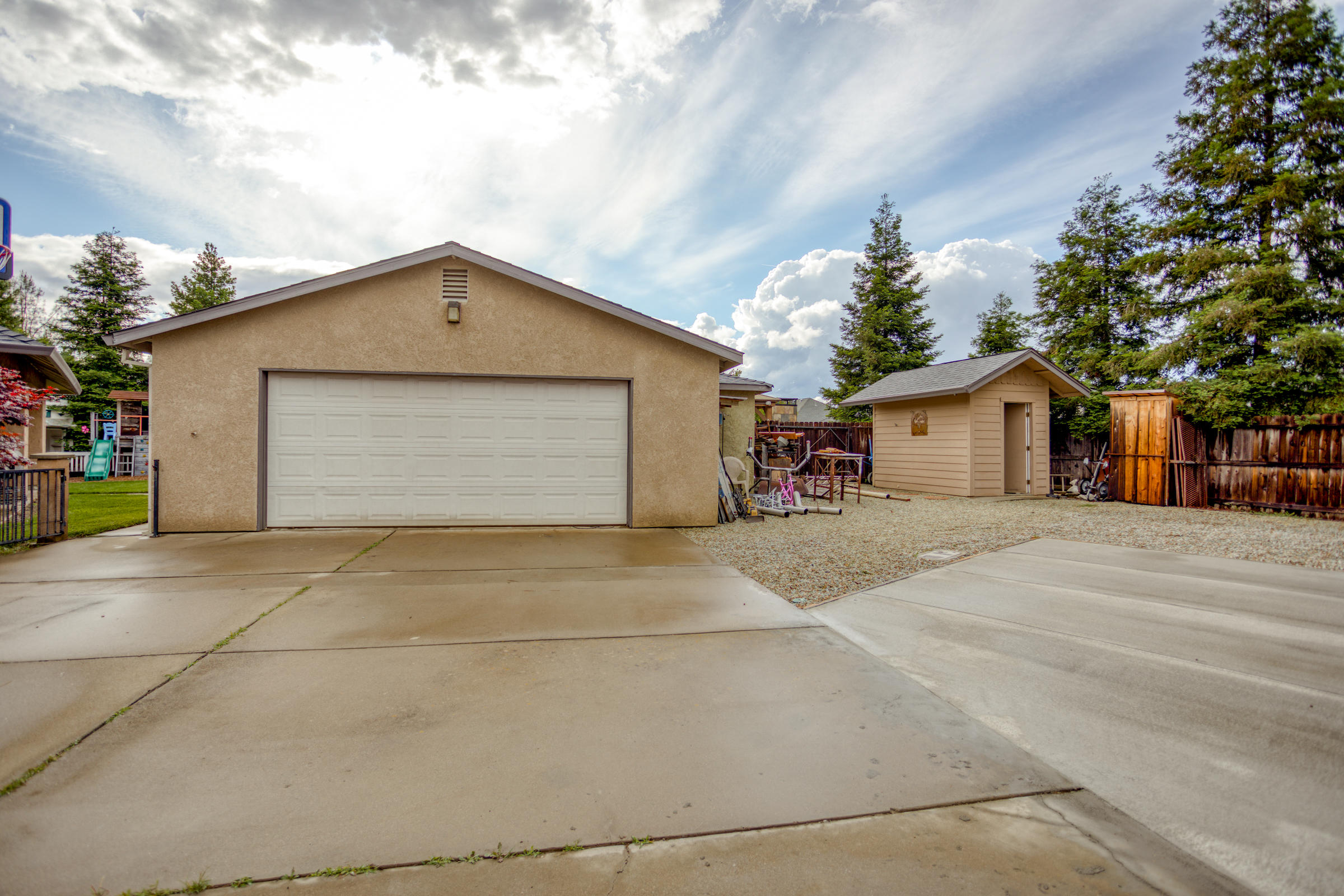 2618 Rhinestone Way Redding, CA 96001 - Photo 54 of 58 a front view of house with garage and trees