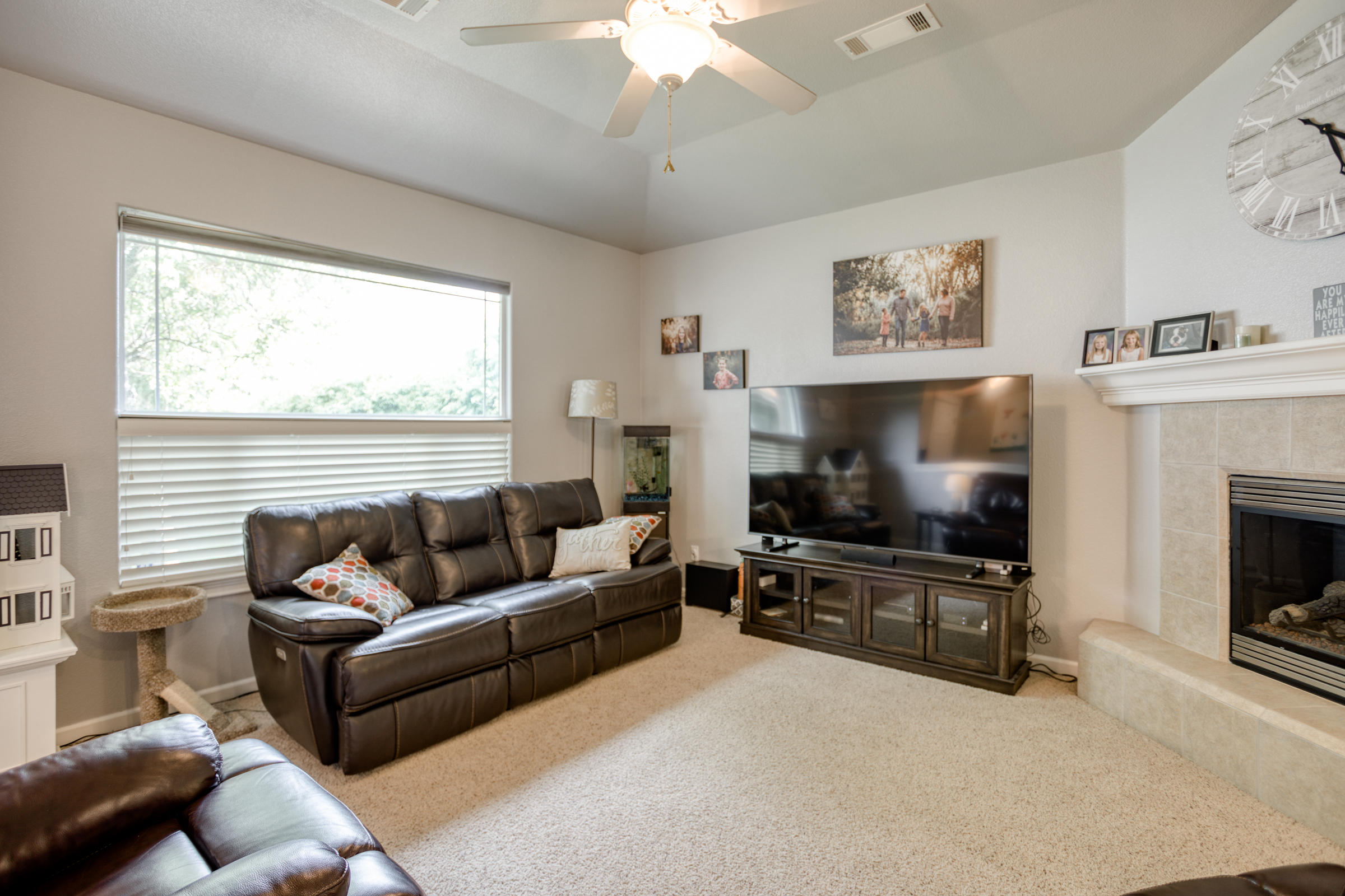 2618 Rhinestone Way Redding, CA 96001 - Photo 10 of 58 a living room with furniture a flat screen tv and a fireplace
