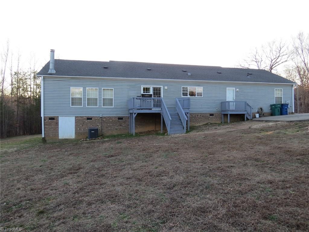 121 Alcorn Loop Ruffin, NC 27326 - Photo 16 of 19 Rear of House with Deck off Kitchen and Tall Crawl Space.