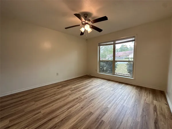 wooden floor in an empty room with a window