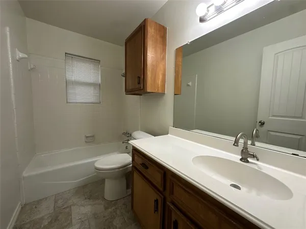 a view of a closet with wooden floor