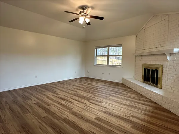 a view of a kitchen a ceiling fan wooden floor and a kitchen