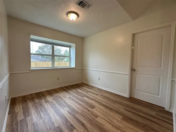 a kitchen with stainless steel appliances granite countertop a stove a sink dishwasher and a microwave oven with wooden floor