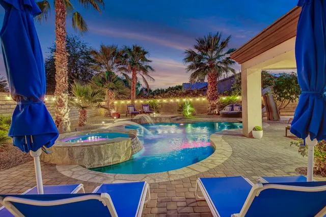 a view of a house with backyard sitting area and garden