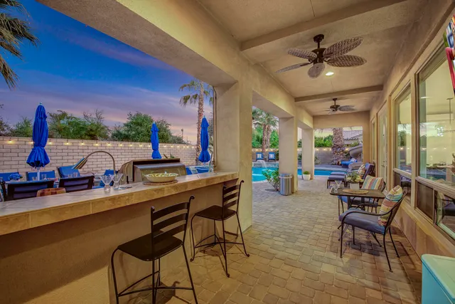 a kitchen with stainless steel appliances granite countertop a stove top oven a sink dishwasher and cabinets with wooden floor