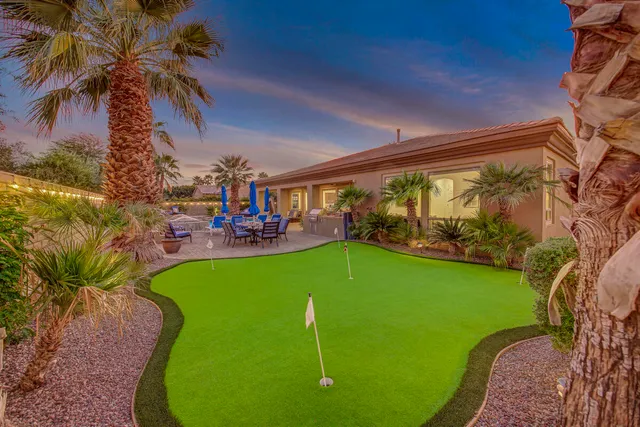 a large bed sitting in a bedroom next to a window