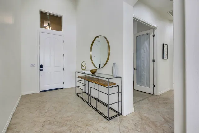 a view of a room that has a bed and a tv in it