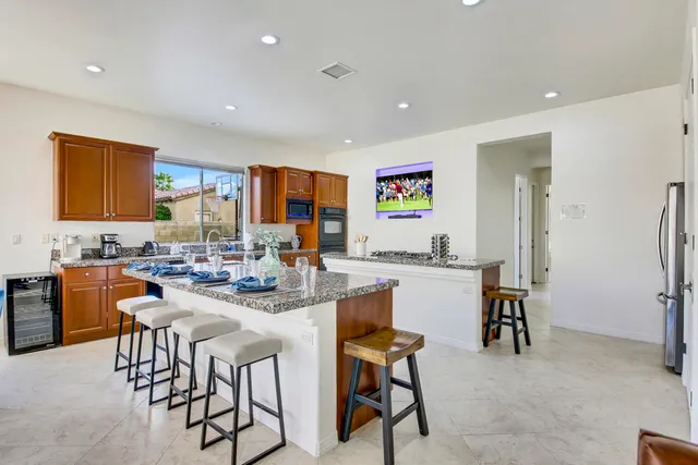 a bedroom with a large bed and wooden floor