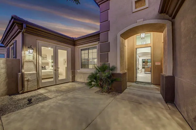 a living room with furniture a large window and a table