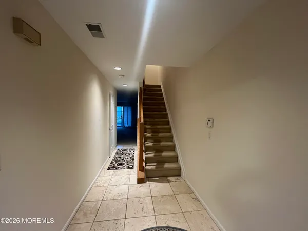 a kitchen with stainless steel appliances granite countertop a refrigerator a stove a sink and a microwave