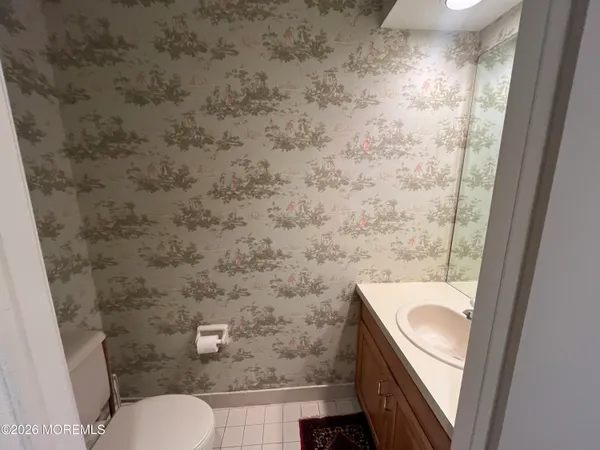 a view of an empty room with a kitchen