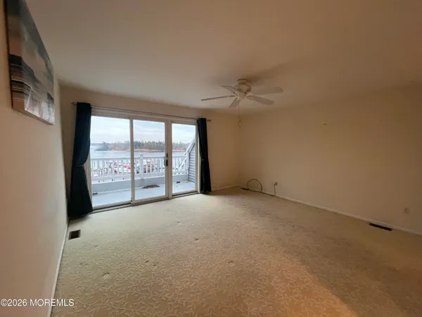 an empty room with a empty space and windows