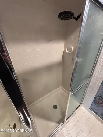a bathroom with a bathtub and shower