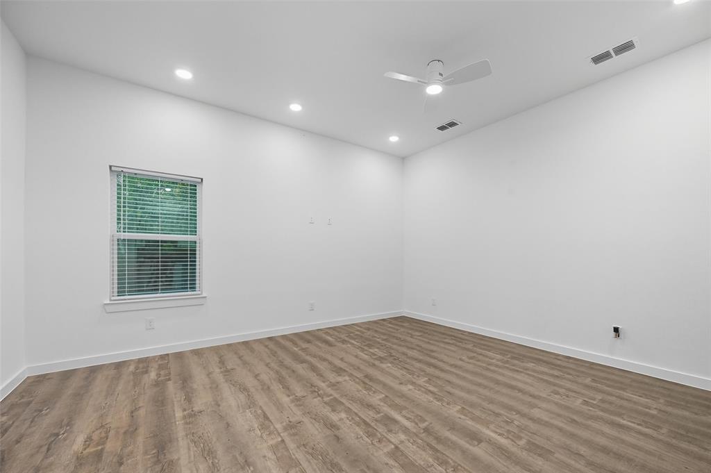 1315 Oneal Street, Unit B Commerce, TX 75428 - Photo 10 of 14 a view of an empty room with wooden floor and a window