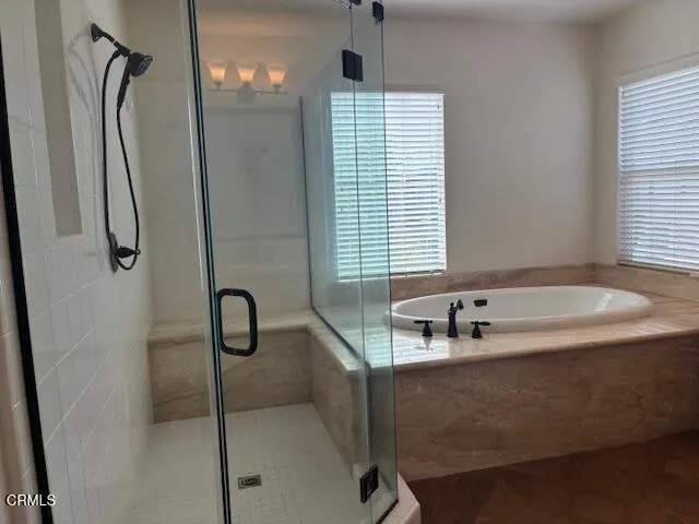 a bathroom with a tub sink and vanity