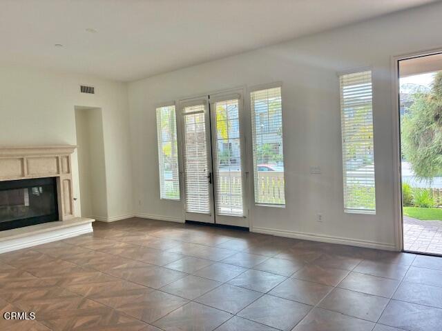 4153 Caribbean Street Oxnard, CA 93035 - Photo 2 of 22 a view of an empty room with a fireplace and a window