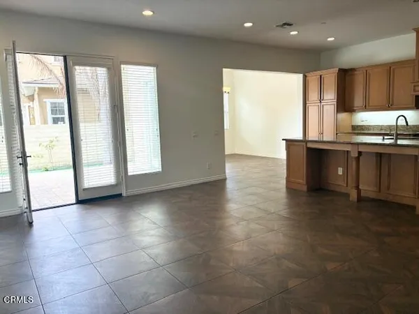 a view of kitchen with granite countertop cabinets and sink