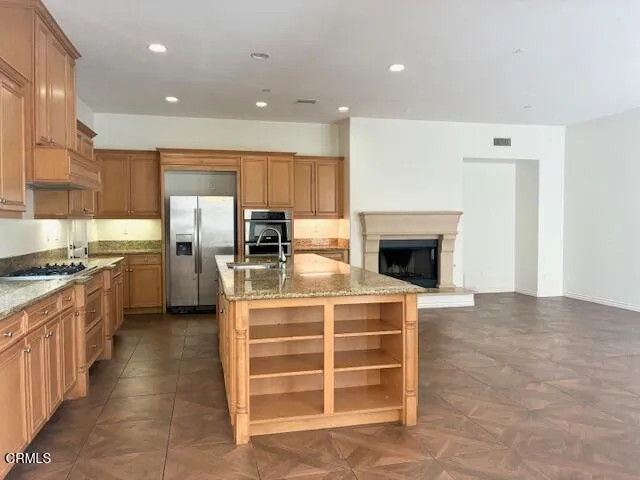 a kitchen with stainless steel appliances a stove and a refrigerator