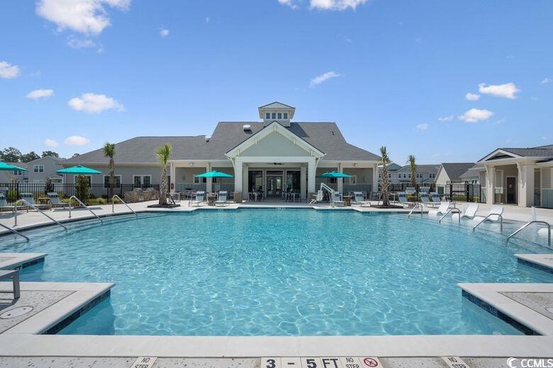 8840 Henry Road, Unit DEWBERRY Longs, SC 29568 - Photo 3 of 29 Community pool featuring a patio area