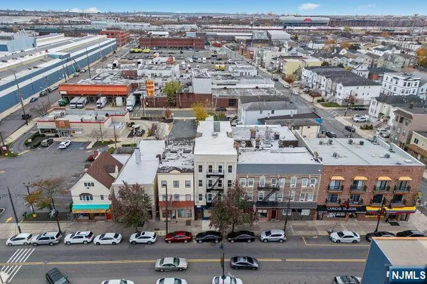 a kitchen with stainless steel appliances white cabinets and wooden floor