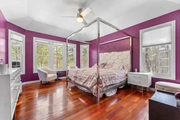 a bed room with a bed and wooden floor