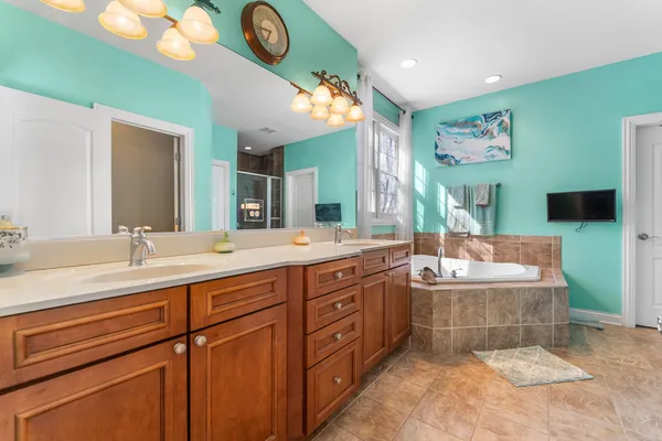 a spacious bathroom with a double vanity sink and a mirror