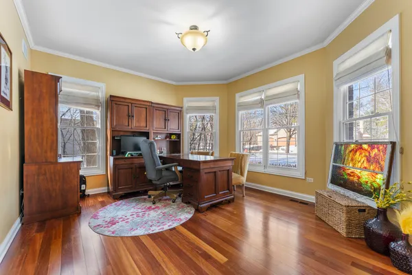 a living room with furniture and a flat screen tv with wooden floor