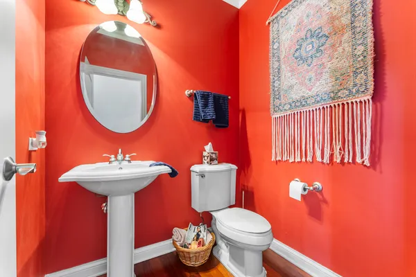 a bathroom with a sink a toilet and a mirror