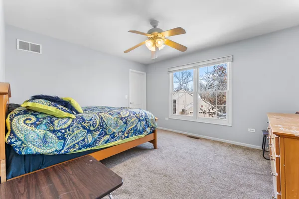 a bedroom with a bed and a painting on the wall