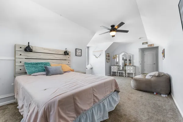a bedroom with a bed and ceiling fan
