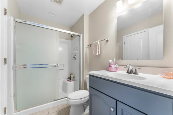 a bathroom with a sink toilet vanity and shower