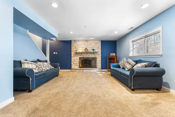 a living room with furniture and a fireplace