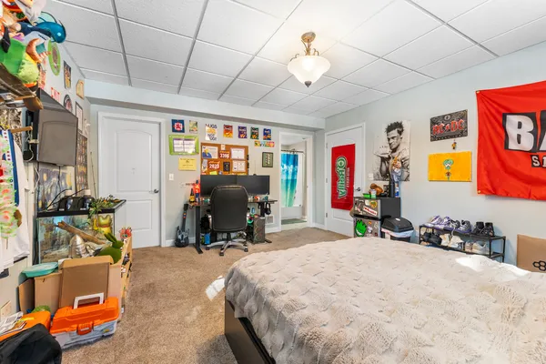 a bed room with a bed and a chair