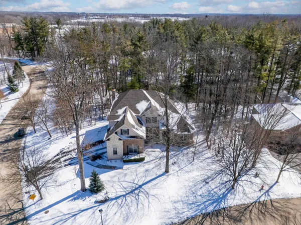 a view of a house with a yard and sitting area