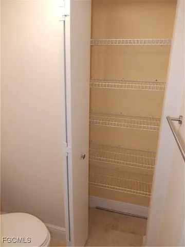 a bathroom with a white toilet and shower