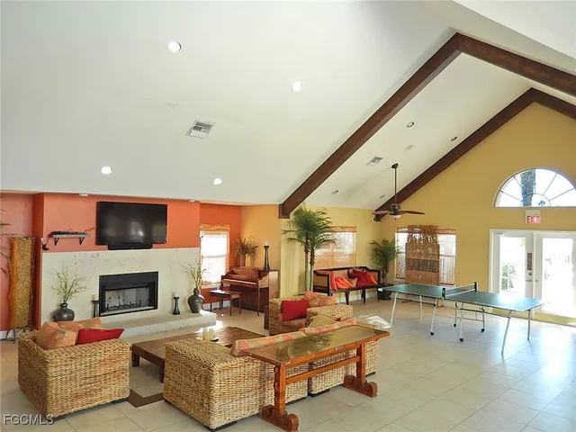 a view of a lake with a yard and large trees