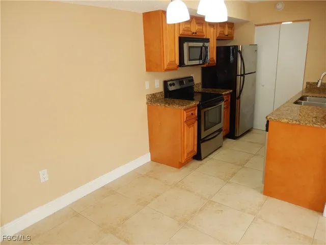 a kitchen with stainless steel appliances a refrigerator and a stove