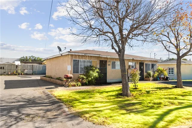 a front view of house with yard and swimming pool